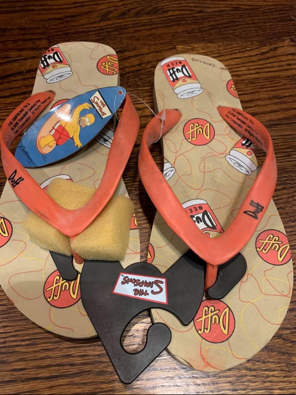 Brand new Size medium  6-7 men’s or women’s Homer Simpson duff beer flip flop